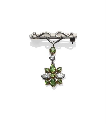 Lot 397 - A Demantoid Garnet and Diamond Brooch/Pendant, a white bar brooch, with a scroll overlay, from...