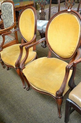 Lot 483 - A pair of Victorian walnut framed elbow chairs