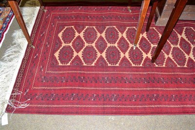 Lot 493 - An Afghan red ground rug