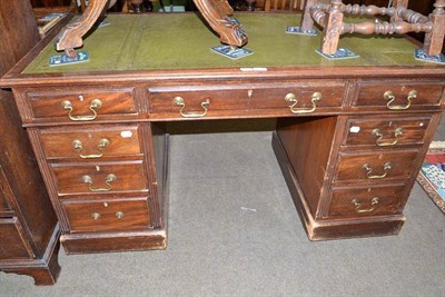 Lot 516 - A mahogany pedestal desk with green leather insert