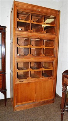 Lot 538 - A glazed showcase cabinet, label marked Dudley & Co Ltd