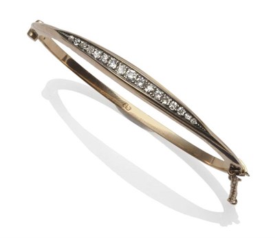 Lot 409 - A Diamond Bangle, circa 1900, the old cut diamonds in white claw settings, within a white boat...