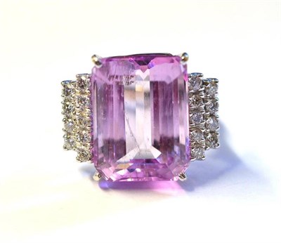 Lot 412 - An 18 Carat White Gold Kunzite and Diamond Ring, the emerald-cut kunzite within two rows of...