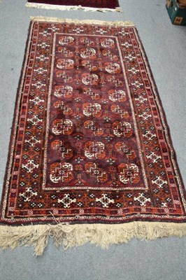 Lot 630 - Afghan Balouch rug West Afghanistan, the aubergine field with three columns of quartered guls,...