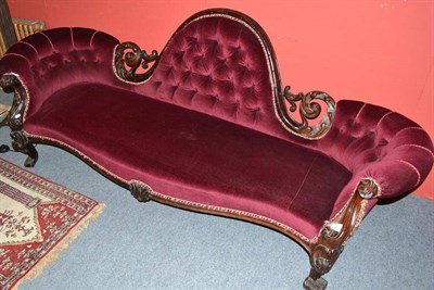 Lot 682 - A Victorian upholstered conversation seat/sofa with two arched ends (feet altered and back leg...