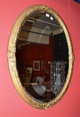 Lot 685 - A large gilt and gesso oval wall mirror