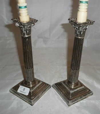 Lot 8 - A pair of late Victorian silver Corinthian column candlesticks, Sheffield 1891, loaded