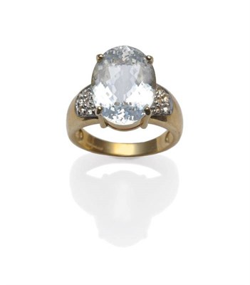 Lot 425 - An 18 Carat Gold Aquamarine Ring, the oval cut aquamarine in a yellow claw setting, clusters of...