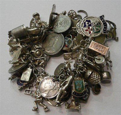 Lot 65 - Silver charm bracelet with quantity of assorted charms