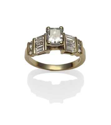 Lot 427 - A Diamond Ring, a princess cut diamond in a four claw setting, to shoulders inset with baguette cut