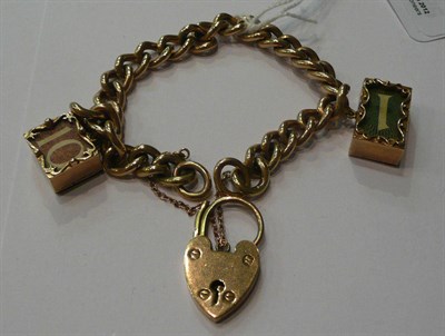 Lot 74 - A curb and lock bracelet hung with a £1 note charm and a 10 shilling note charm