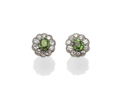 Lot 433 - A Pair of Platinum Demantoid Garnet and Diamond Cluster Stud Earrings, each with an oval cut...