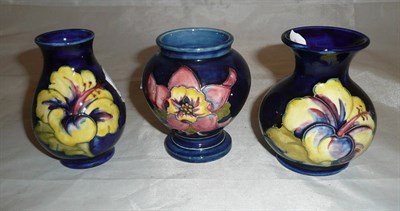 Lot 131 - Two Walter Moorcroft hibiscus vases and another (3)