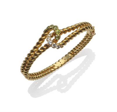 Lot 434 - A Diamond and Demantoid Garnet Bangle, signed Boucheron, the double rope twist bangle with entwined