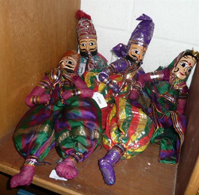 Lot 146 - Four Indian decorative dolls with carved heads, wearing embroidered costumes