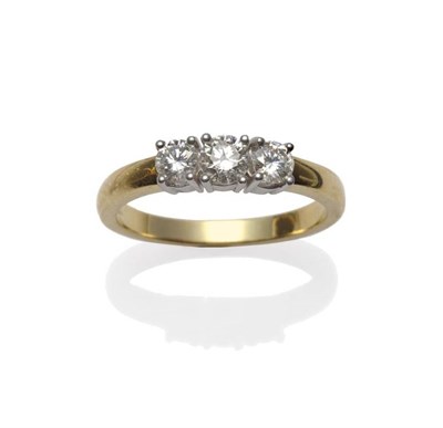 Lot 435 - An 18 Carat Gold Diamond Three Stone Ring, the round brilliant cut diamonds, in white claw...