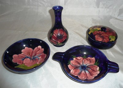 Lot 154 - Four pieces of Walter Moorcroft, anemone vase, hibiscus bowl, hibiscus powder bowl and anemone...