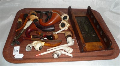 Lot 177 - Carved oak pipe stand with embossed plaque and assorted meerschaum pipes, clay pipes