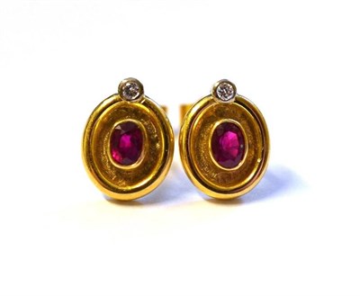 Lot 438 - A Pair of 18 Carat Gold Ruby and Diamond Earrings, an oval cut ruby within a yellow rubbed over...