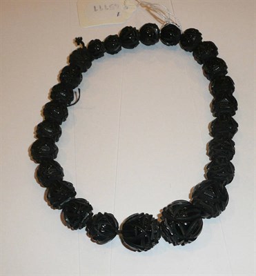 Lot 220 - A necklace of graduated carved jet beads