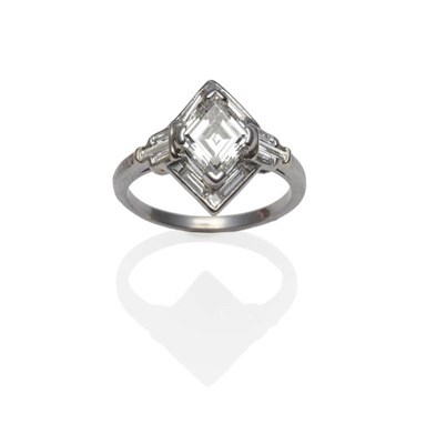 Lot 443 - A Diamond Cluster Ring, a diamond shaped step cut centre stone, within a border of baguette cut and