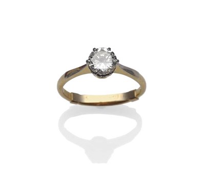 Lot 444 - A Diamond Solitaire Ring, the brilliant cut diamond in a white claw setting, on white fronted...