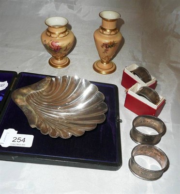 Lot 254 - Two Worcester blush ivory vases, four silver napkin rings and a silver shell dish