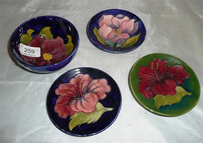 Lot 259 - Four pieces of Walter Moorcroft - two hibiscus dishes, magnolia dish and a clematis bowl