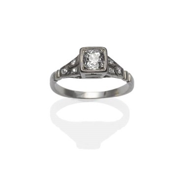 Lot 447 - A Diamond Ring, circa 1930, an old cut diamond in a white squared setting, within pierced geometric