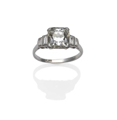 Lot 451 - A Diamond Solitaire Ring, circa 1930, the old mine cut diamond in a white four claw setting, a pair