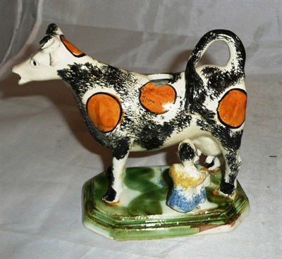 Lot 315 - Sponge decorated cow creamer