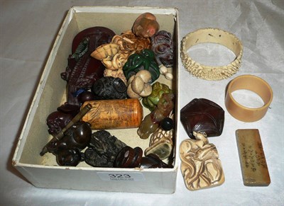 Lot 323 - Assorted netsukes, carved stone etc