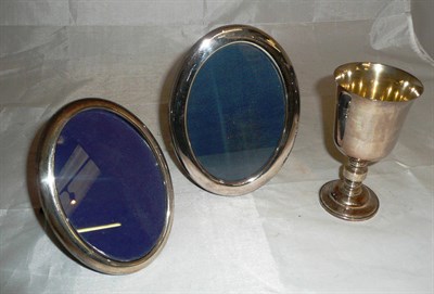 Lot 365 - Two oval silver photograph frames and a silver goblet