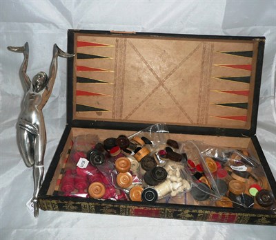 Lot 383 - A stained bone chess set in a book form case and a chrome figure