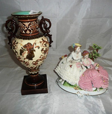 Lot 385 - A German porcelain figure group of crinoline ladies and a Continental two handled vase