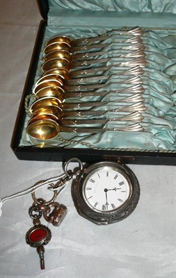 Lot 416 - A silver pocket watch in pair case and twelve egg spoons (cased)