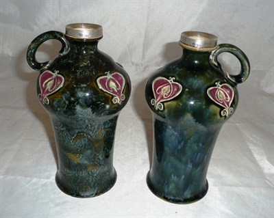 Lot 433 - Two Doulton stoneware Art Nouveau vases with silver mounted collars