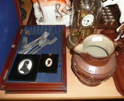 Lot 475 - A mahogany canteen with plated flatware, two framed silhouettes, clock under glass dome and a...