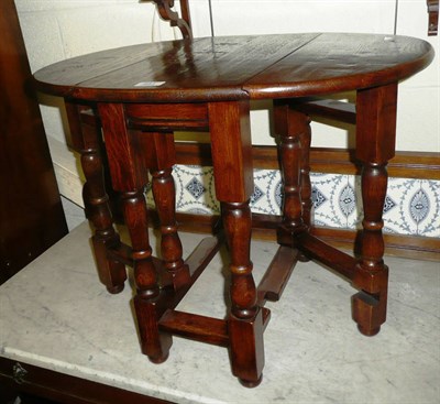 Lot 581 - Reproduction oak occasional table modelled as a gate leg