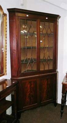 Lot 584 - A George III mahogany glazed corner cabinet