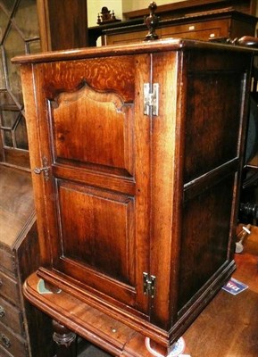 Lot 617 - A Titchmarsh and Goodwin oak cabinet with single door