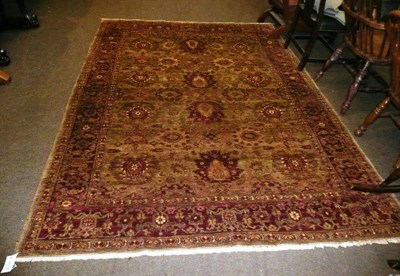 Lot 644 - An Oriental carpet with red and green ground, 264cm by 185cm