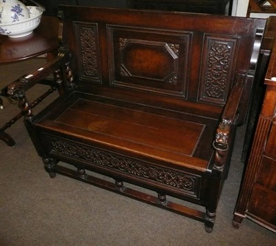 Lot 656 - Carved oak monks bench