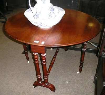 Lot 657 - A Victorian mahogany Sutherland table with turned supports and ceramic castors