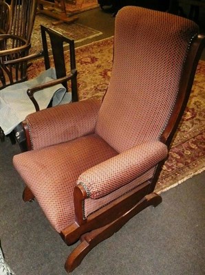 Lot 658 - An oak framed upholstered American style rocking chair and a mahogany open armchair