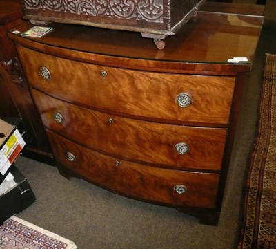 Lot 692 - Flame mahogany three height bow-fronted chest of drawers, with glass protector