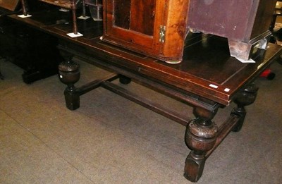 Lot 706 - A large carved oak draw leaf table