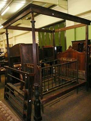 Lot 712 - A 19th century mahogany four poster bed and a child's cot with painted decoration