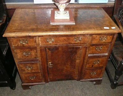 Lot 740 - A walnut kneehole desk