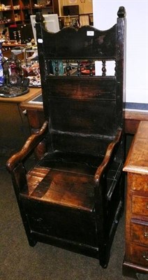 Lot 741 - Oak panel back box chair, carved oak cupboard door and carved oak panel (3)